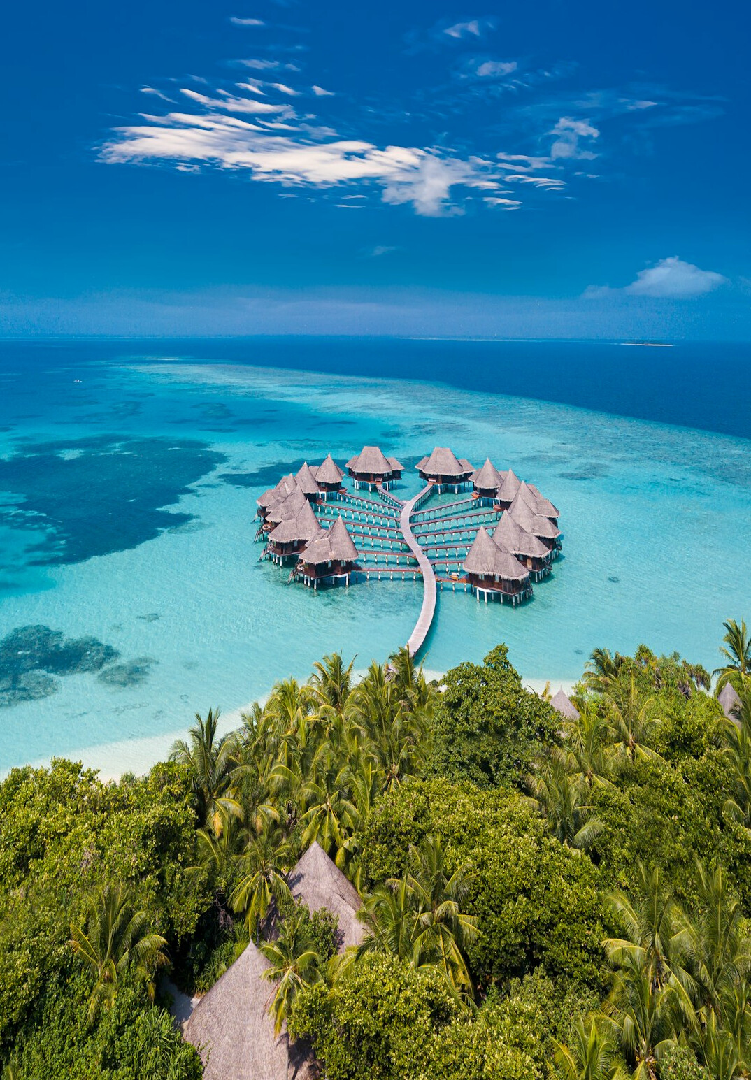 Overwater villas on a turquoise lagoon in the Maldives
