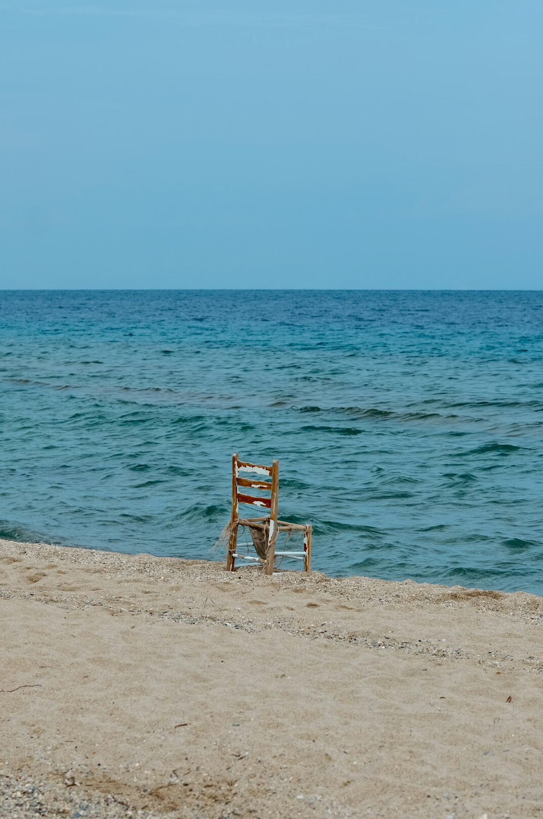 Empty beach with calm sea and blue sky