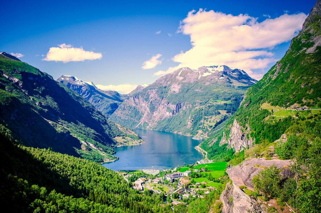 Mountain lake surrounded by steep green hills in Norway