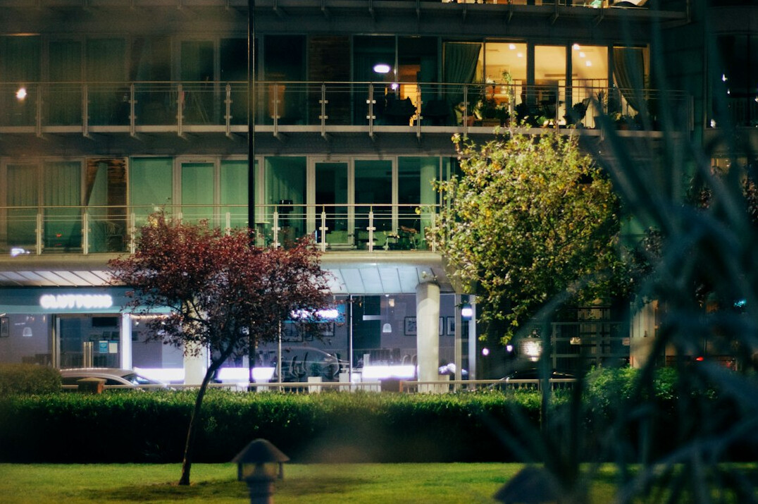 Modern hotel exterior with garden at dusk