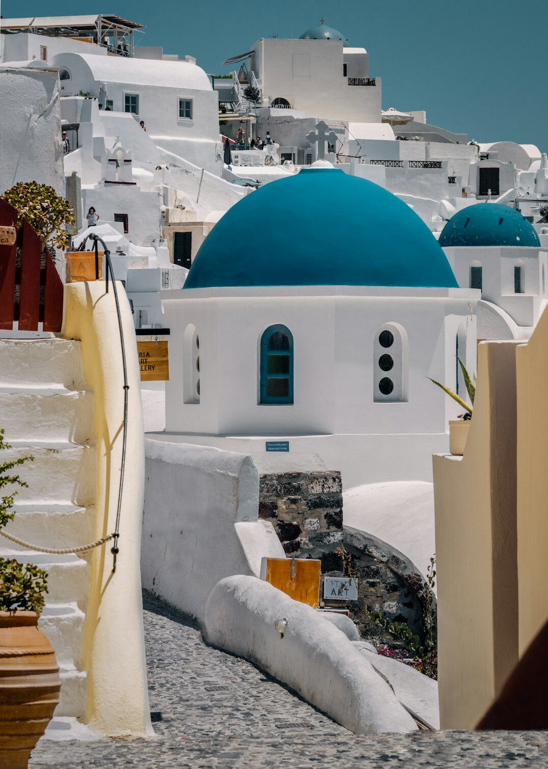 White buildings and blue domes of Santorini above the sea